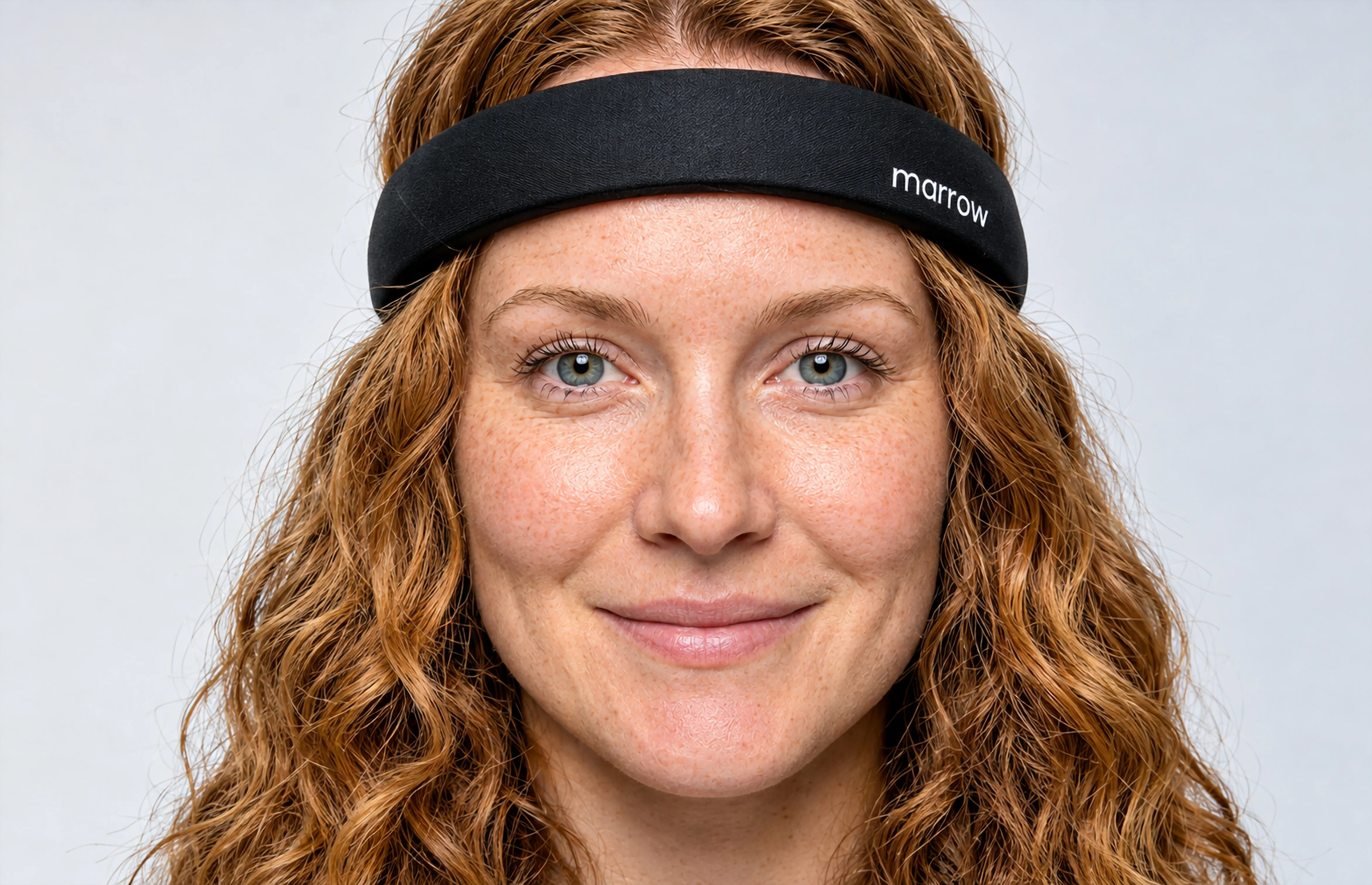 A person wearing the Marrow headband, smiling